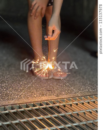 Children playing sparklers during summer vacation 133137978