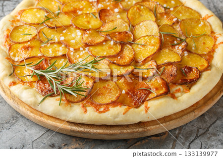 Mozzarella potato pizza and sprinkle with rosemary, salt, pepper closeup on the wooden board. Horizontal Mozzarella potato pizza and sprinkle with rosemary, salt, pepper closeup on the wooden board. Horizontal 133139977