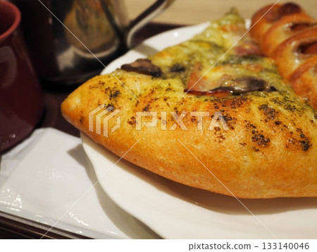 A warm morning at the cafe, featuring pizza bread with plenty of toppings and coffee A warm morning at the cafe, featuring pizza bread with plenty of toppings and coffee 133140046