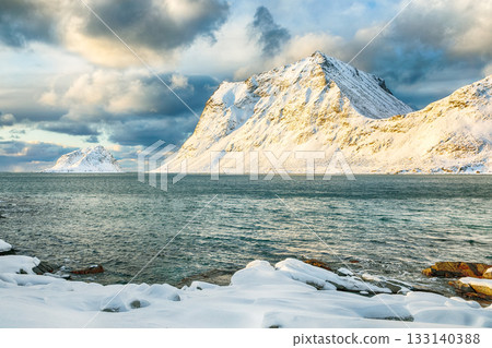 Amazing winter view of Vik and Haukland beaches during sunset with lots of snow and snowy mountain peaks near Leknes Amazing winter view of Vik and Haukland beaches during sunset with lots of snow and snowy mountain peaks near Leknes 133140388