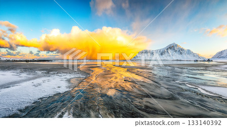 Amazing winter scenery on Skagsanden beach with illuminated clouds during sunrise 133140392