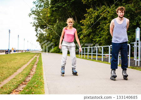 Young people casually rollblading together. Young people casually rollblading together. 133140685