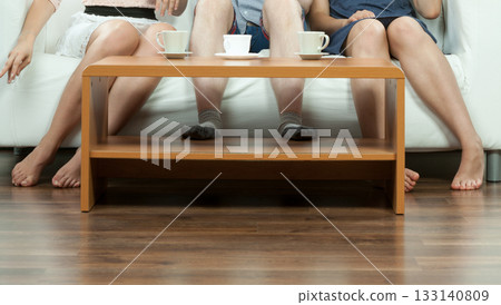Happy friends sitting on sofa. Happy friends sitting on sofa. 133140809