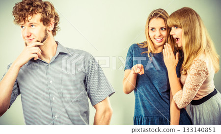 Two women talking gossiping about man. Two women talking gossiping about man. 133140851