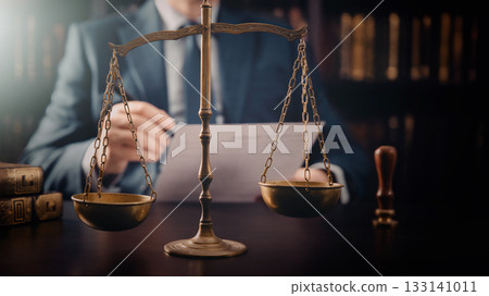 Weight scale of justice, lawyer in background Weight scale of justice, lawyer in background 133141011
