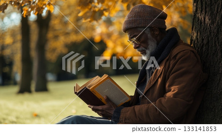 A peaceful moment in autumn. An elderly man reads a book under a tree surrounded by fall colors. Enjoy nature and reading for a serene experience. Generative AI 133141853