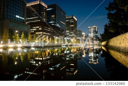 Nighttime office district reflected on the water Nighttime office district reflected on the water 133142060