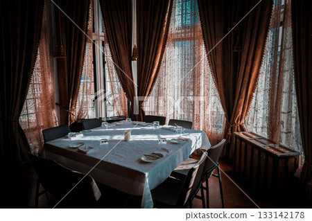 Dining room with curtains and table 133142178