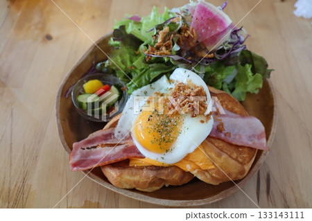 Cheddar cheese and soft-boiled egg croissant sandwich with colorful salad Cheddar cheese and soft-boiled egg croissant sandwich with colorful salad 133143111