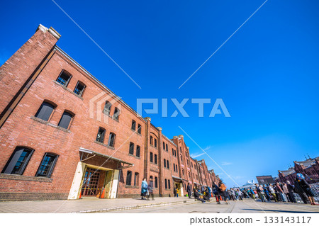 Yokohama cityscape in Japan, overlooking the Yokohama Red Brick Warehouse and other attractions. The new passenger ship Asuka III can be seen in the background at Osanbashi Pier (15th) 133143117