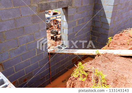 Construction site showing brick wall with window opening Construction site showing brick wall with window opening 133143143