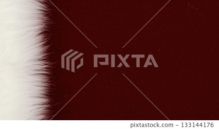 A close-up macro shot features a luxurious white faux fur border on the left, contrasting sharply with a rich, dark red velvet fabric providing ample copy space on the right. 133144176