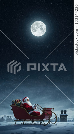 Santa Claus sits in his red sleigh filled with wrapped gifts on a snow-covered rooftop under a bright full moon and starry night sky, with distant chimneys visible. 133144226