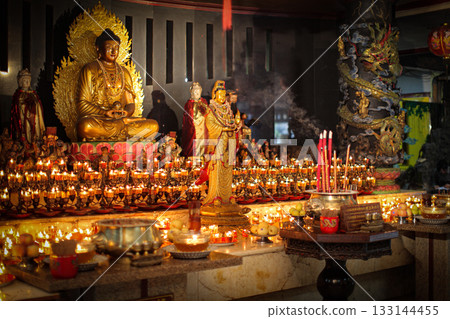 Serene Buddha Statue Amid Colorful Shrine Decor For Meditation, Peace, And Spirituality 133144455