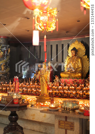Serene Buddha Statue Amid Colorful Shrine Decor For Meditation, Peace, And Spirituality Serene Buddha Statue Amid Colorful Shrine Decor For Meditation, Peace, And Spirituality 133144458