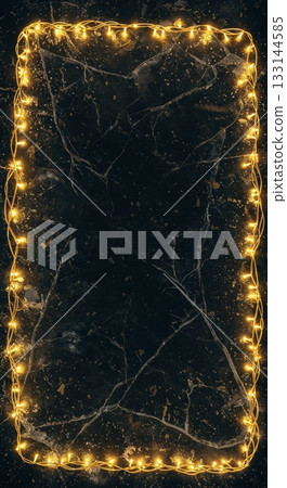 Glowing yellow fairy lights intricately form a radiant rectangular border on a luxurious dark black marble surface, providing elegant copy space in a top-down composition. 133144585