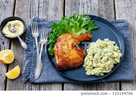 roast chicken leg with coleslaw on a plate 133144706