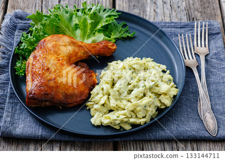 roast chicken leg with coleslaw on a plate 133144711