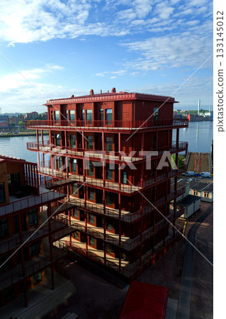 Sustainable cabins with natural materials on waterfront in Kvillepiren, Hisingen, sunny day, Gothenburg, Sweden Sustainable cabins with natural materials on waterfront in Kvillepiren, Hisingen, sunny day, Gothenburg, Sweden 133145012