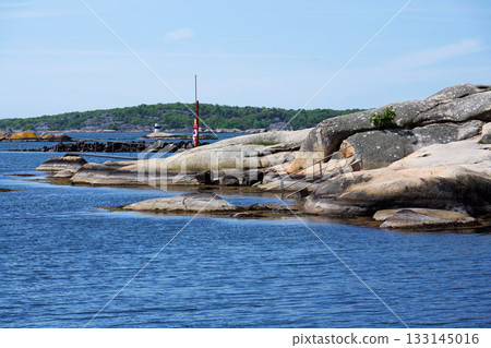 Rocks around public sea bath of Saltholmen peninsula on shore of Alvsborgsfjorden harbour, Alvsborg district, sunny day, Gothenburg, Sweden 133145016