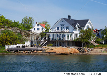 Houses on the rocks of Saltholmen peninsula on shore of Alvsborgsfjorden harbour, Alvsborg district, sunny day, Gothenburg, Sweden Houses on the rocks of Saltholmen peninsula on shore of Alvsborgsfjorden harbour, Alvsborg district, sunny day, Gothenburg, Sweden 133145019