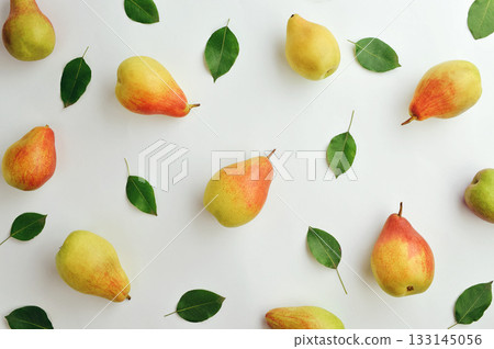 Light autumn background. Ripe yellow fragrant pears and grapes. Thanksgiving background. Fruits on a light background. 133145056