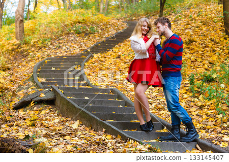 Romantic pair meet in park standing on stairs. Romantic pair meet in park standing on stairs. 133145407
