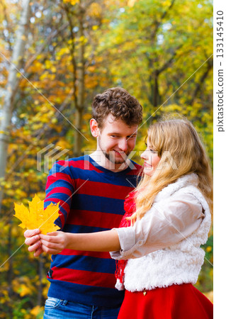 couple playing with leaf in autumn park couple playing with leaf in autumn park 133145410
