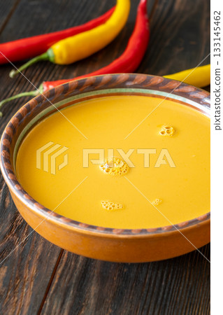 Creamy bisque served in clay bowl placed on rustic wooden table Creamy bisque served in clay bowl placed on rustic wooden table 133145462