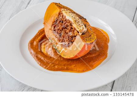 Portion of baked Hokkaido pumpkin with beef, tomato sauce, mozzarella cheese Portion of baked Hokkaido pumpkin with beef, tomato sauce, mozzarella cheese 133145478