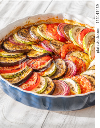 Round baking pot filled with circularly arranged baked vegetable ratatouille Round baking pot filled with circularly arranged baked vegetable ratatouille 133145489