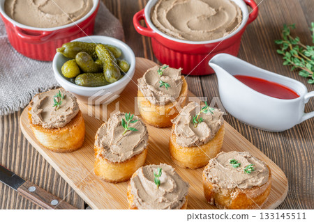 Turkey liver pate on toast with cornichons and cranberry sauce beside Turkey liver pate on toast with cornichons and cranberry sauce beside 133145511
