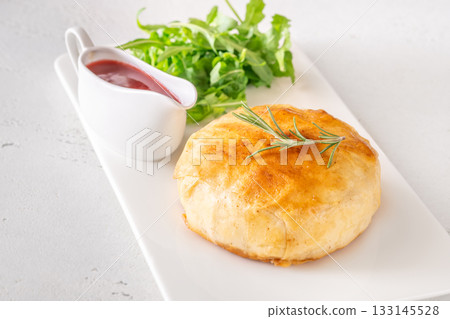 Golden Camembert en Croute with rosemary sprig and deep red cranberry sauce 133145528