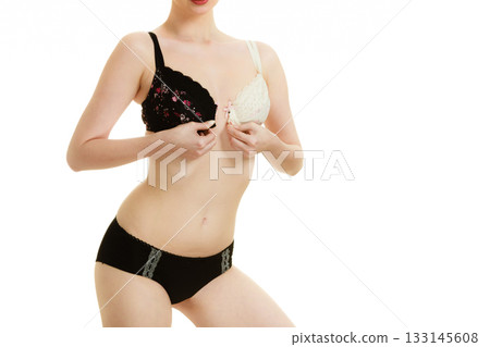 Lady with choice trying to choose perfect bra. Lady with choice trying to choose perfect bra. 133145608