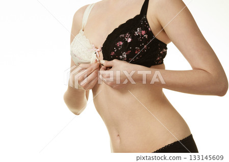 Girl of smooth body with brassiere dilemma. Girl of smooth body with brassiere dilemma. 133145609