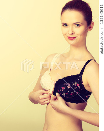 Woman choosing color bra black or white 133145611