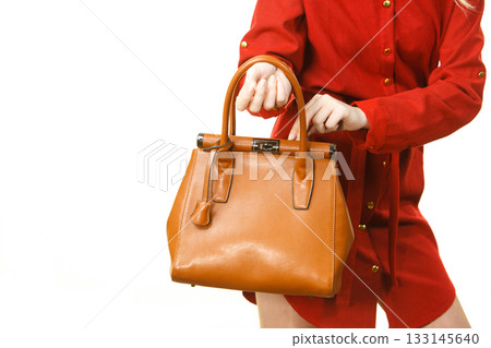Female wearing red dress holding bag Female wearing red dress holding bag 133145640