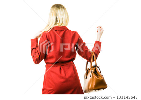 Female wearing red dress holding bag Female wearing red dress holding bag 133145645