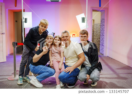 Family enjoying a fun moment in a brightly lit space 133145707