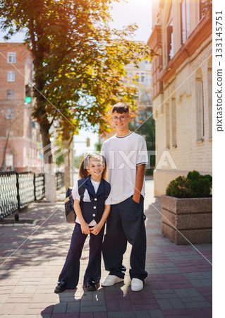Two siblings enjoying a sunny day on the street near their home Two siblings enjoying a sunny day on the street near their home 133145751