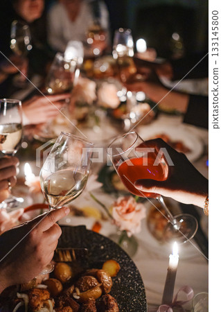 Celebration with toasting glasses at a festive dinner 133145800