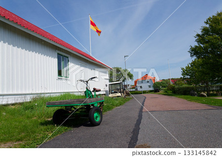 Flatbed moped parked on street of the peaceaful car-free Vrango island with seaside village in Gothenburg archipelago, Vrango, Sweden Flatbed moped parked on street of the peaceaful car-free Vrango island with seaside village in Gothenburg archipelago, Vrango, Sweden 133145842
