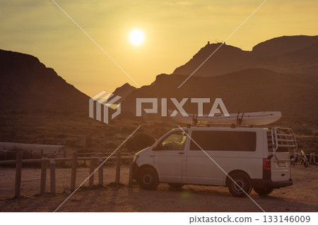 Car with canoe on top roof at sunset 133146009