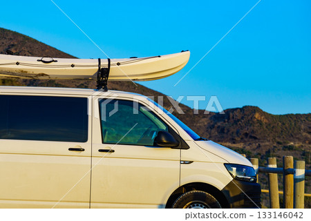 Canoe on roof top of car van 133146042