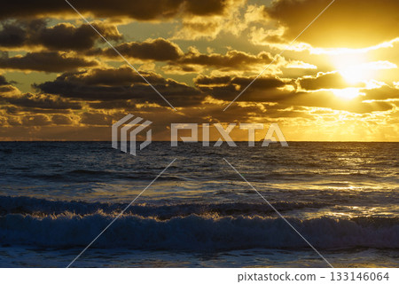 Sunset over sea, stormy clouds 133146064