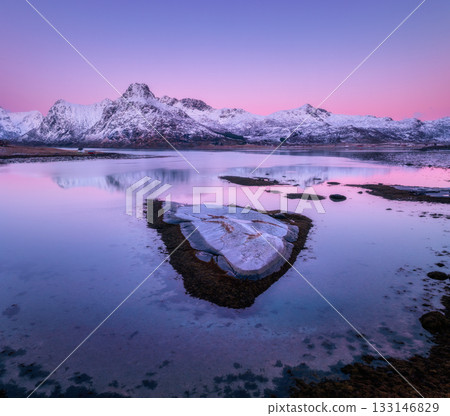 Aerial view of stones, calm water with snow-covered rocks Aerial view of stones, calm water with snow-covered rocks 133146829