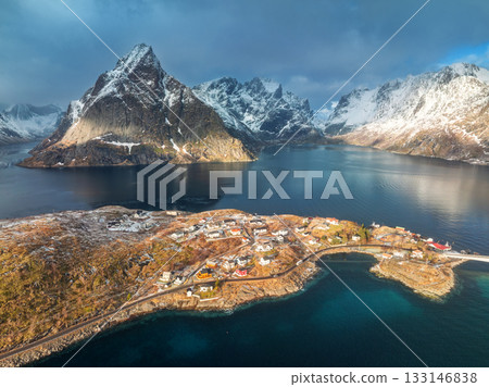 Aerial view of snowy rocks, village, sea, bridge, dramatic sky Aerial view of snowy rocks, village, sea, bridge, dramatic sky 133146838