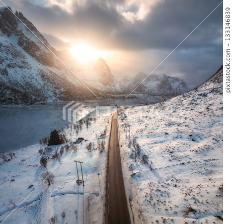 Aerial view of winter road at sunset. Lofoten islands, Norway Aerial view of winter road at sunset. Lofoten islands, Norway 133146839