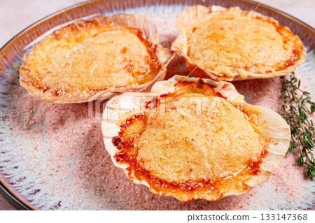 scallop, baked in shells, with cheese and spices, on a plate, homemade, 133147368