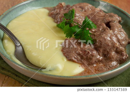 liver beef stroganoff with mashed potatoes, table setting in green tones, homemade, 133147389